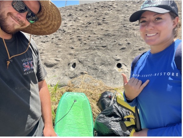 Tiara and Research Assistant, Naha Pierce, remove trash debris from Wailuku Stream.