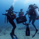Staff members of Maui Nui Marine Resource Council in dive gear learn to collect corals of opportunity.